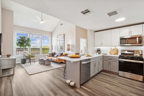 a living room with a kitchen and a dining room at Metro 303, Hempstead, New York