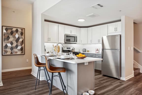 a kitchen with a island and stainless steel refrigerator at Metro 303, New York
