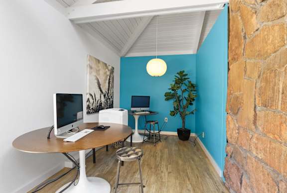 A room with a desk and a computer monitor.