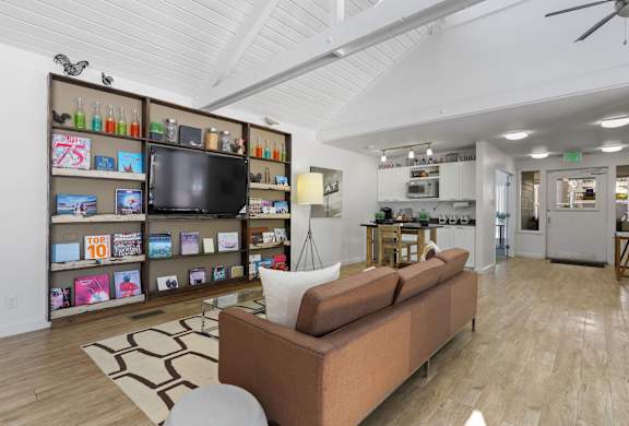 A living room with a couch and a television.