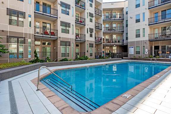 A swimming pool in front of apartment buildings at Regatta Sloans Lake Apartments, Denver