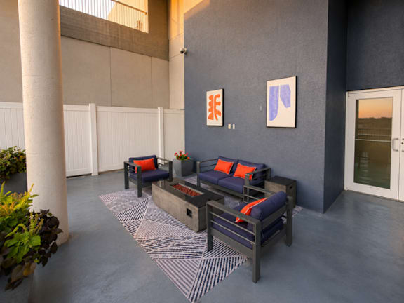 Resident courtyard with modern seating and artwork at 222 Saratoga Apartments, Baltimore, 21202