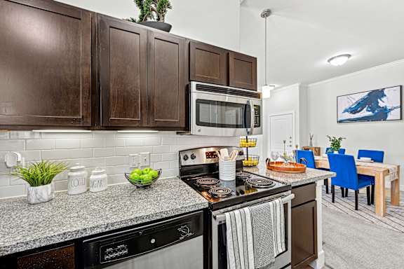 Brown Cabinets in Kitchen at The Laurel at Vintage Park 55+ Apartments, Tomball Texas