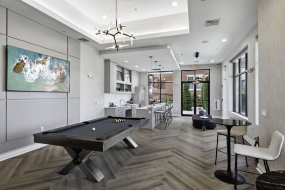 a game room with a pool table and a bar at West 130, West Hempstead