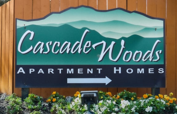 the sign for cascade woods apartment homes