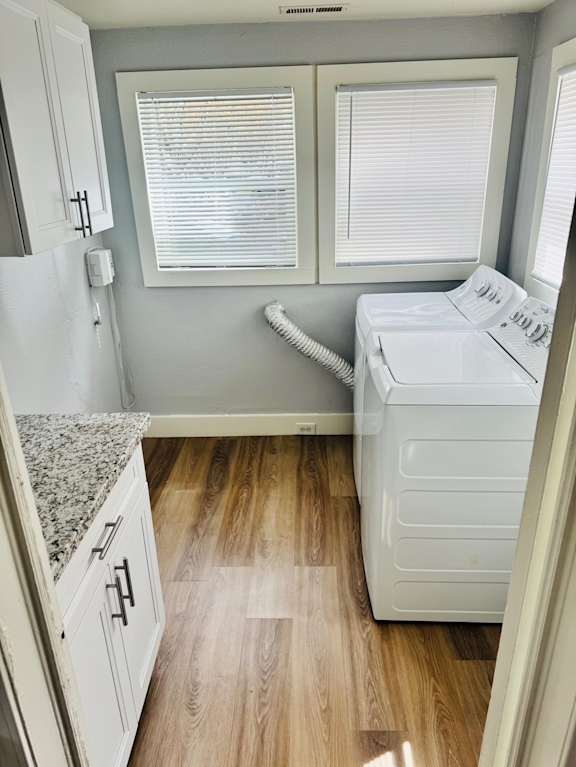 A small laundry room with a washer and dryer.