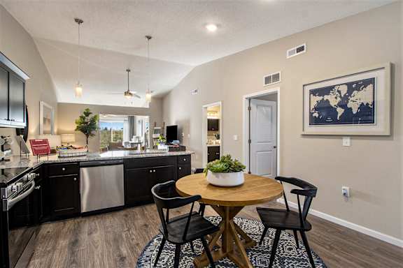 A modern kitchen with a dining table and chairs.