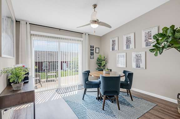 A dining room with a table set for four.
