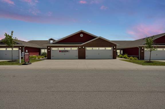 A red building with a garage door sign that says "Frontier".