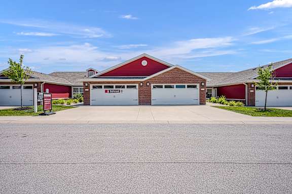 A red building with a white garage door in front.