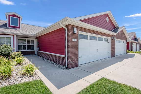 A red house with a white garage door.