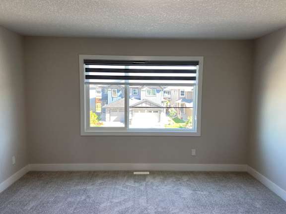 A room with a window overlooking a street.