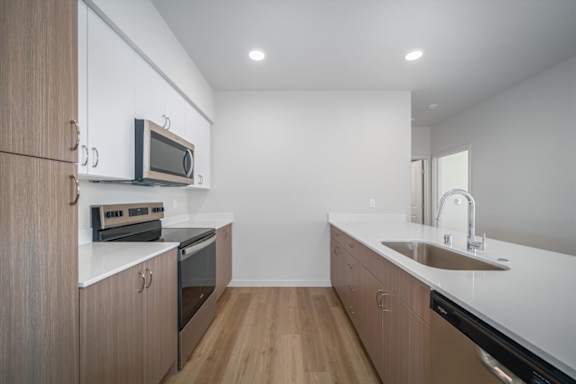 A modern kitchen with wooden cabinets and stainless steel appliances.