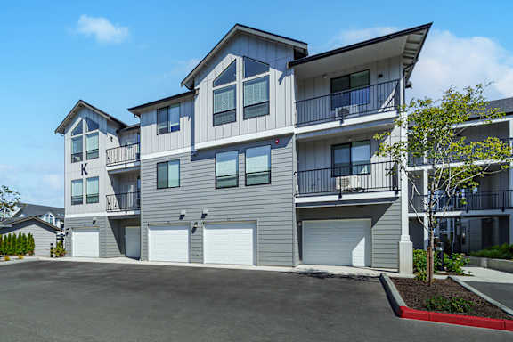 A modern two-story residential building with a garage.