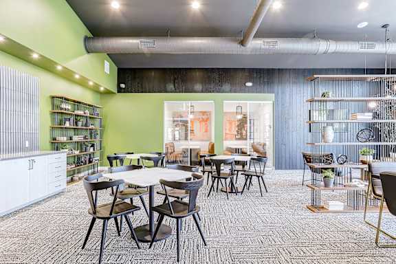 a dining room with tables and chairs and a library