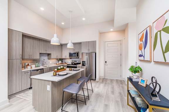 A kitchen with a table and chairs in front of it. at Morea Apartments, Pompano Beach, 33062