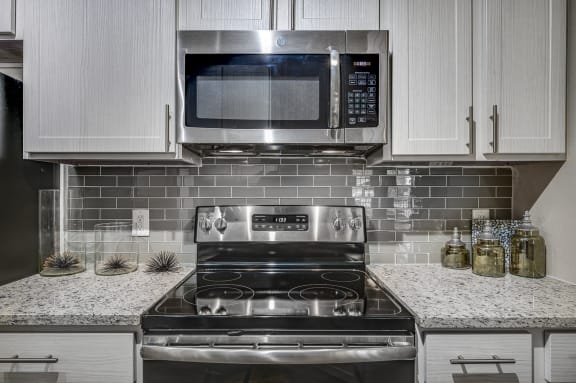 Kitchen with Glass Backplash at Riachi at One21, Texas, 75025