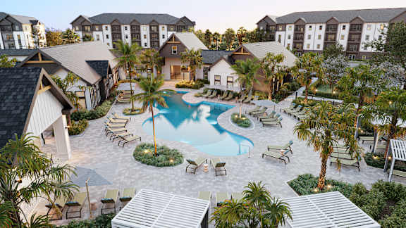 A resort with a swimming pool surrounded by palm trees.