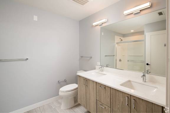 A white toilet sits next to a sink in a bathroom.