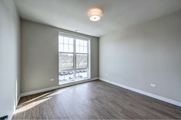A room with a window and sliding glass doors.