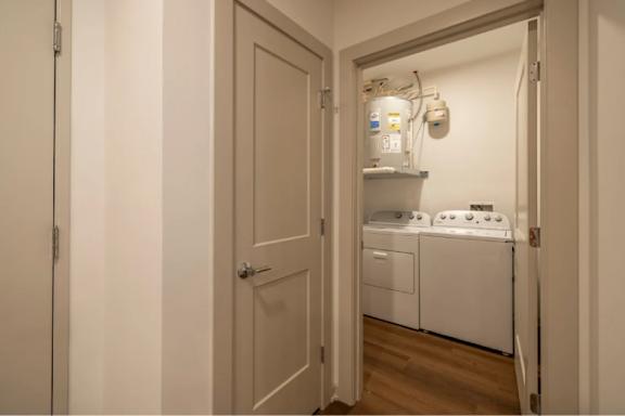 A small laundry room with a washer and dryer.