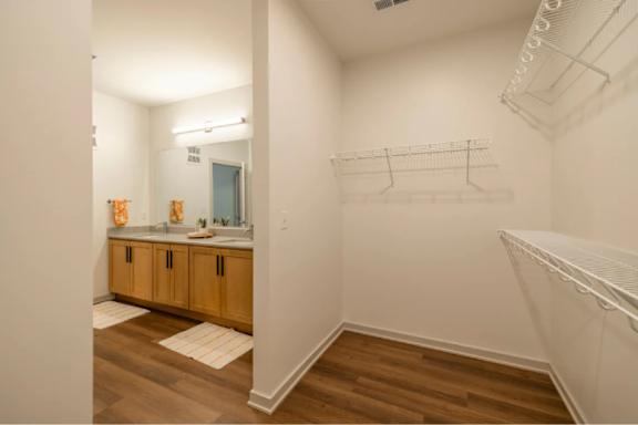 A small bathroom with a sink and wooden floors.