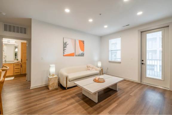 A living room with a white couch and a coffee table.