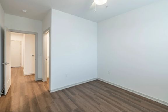 A room with white walls and wood flooring.