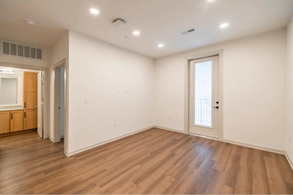 A room with wooden floors and white walls.