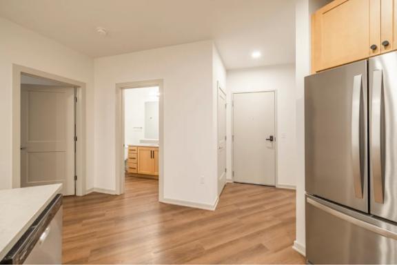A kitchen with a refrigerator on the right.