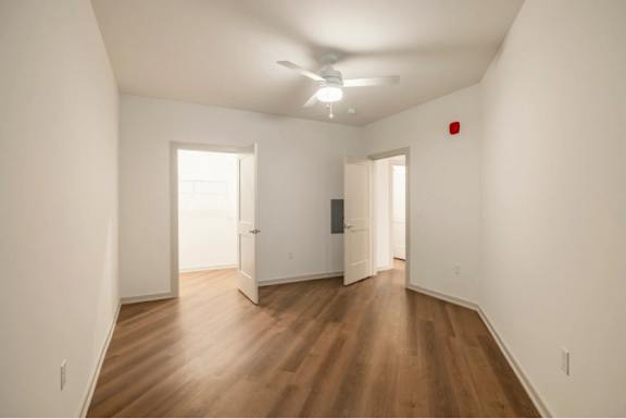 A room with wooden floors and white walls.
