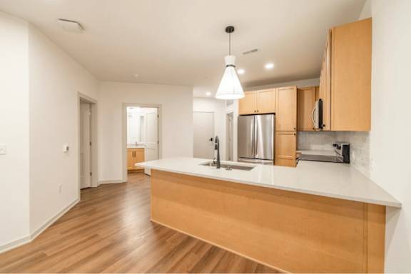 A kitchen with wooden cabinets and a white countertop.