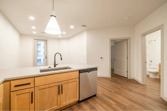 A kitchen with wooden cabinets and a white countertop.