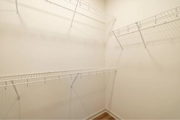A white wall with a metal rack on it.