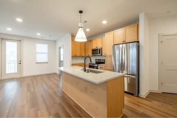 A kitchen with wooden cabinets and a white countertop.