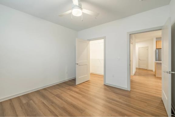 A room with wooden floors and white walls.