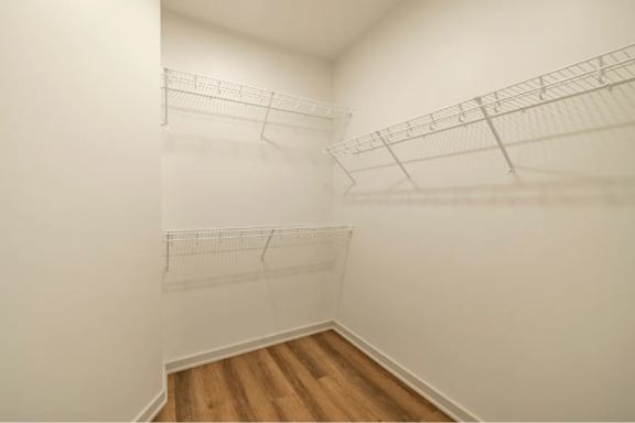 Empty room with white walls and wooden floor.