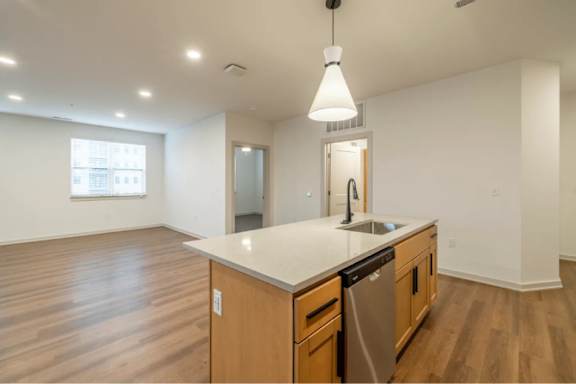 A kitchen with wooden cabinets and a white countertop.