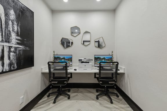 a home office with two desks and two computer monitors at Wellington at Willow Bend Apartments, Plano