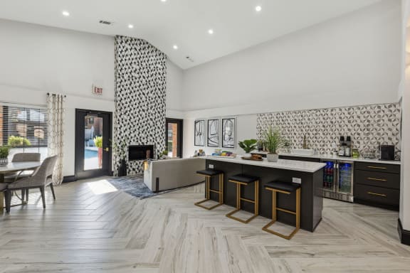 a living room with a kitchen and a fireplace at Wellington at Willow Bend Apartments, Plano, Texas