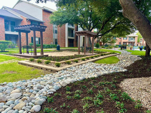 a garden with rocks and a stone path at Wellington at Willow Bend Apartments, Texas