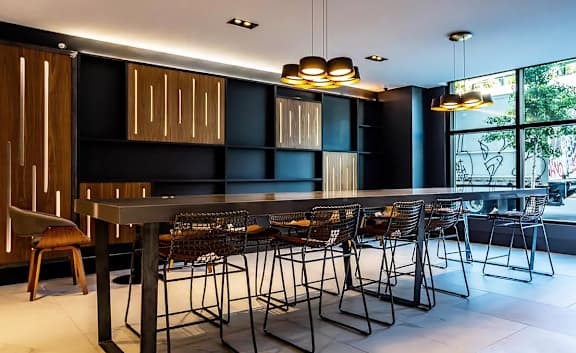 Modern communal dining area with bar seating at 1134 Fulton Street Apartments, Brooklyn, 11216