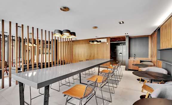 Community dining area with modern lighting and wood accents at 1134 Fulton Street Apartments, Brooklyn, New York
