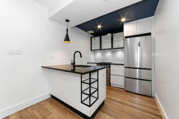 A modern kitchen with a black and white color scheme.
