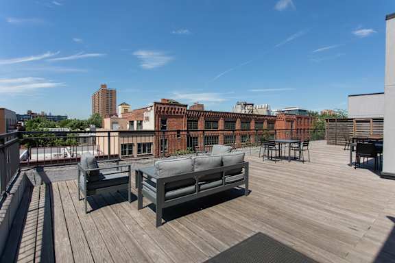 A wooden deck with a bench and a table.