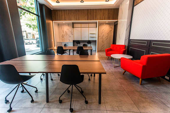 A conference room with a long table and chairs.
