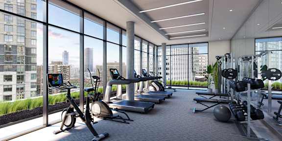 a gym with floor to ceiling windows and exercise equipment at The Lively, New Jersey