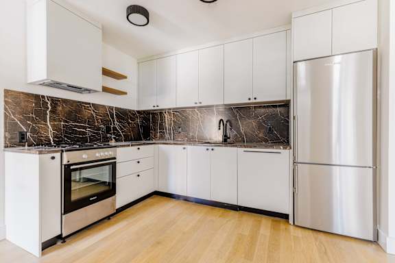 Modern kitchen with dark marble backsplash at 260 Gold Apartments, Brooklyn, New York