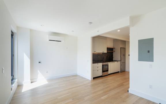 an empty living room and kitchen in a house