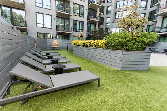 Rooftop sundeck with lounge chairs and artificial turf at 1134 Fulton Street Apartments, Brooklyn, NY 11216